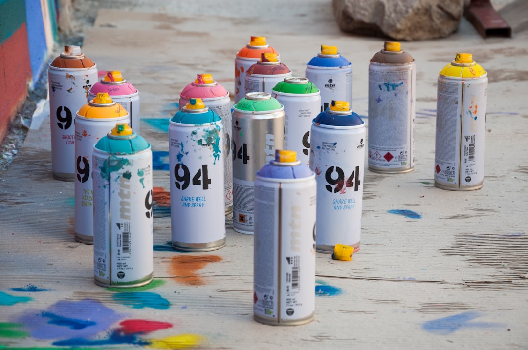 a group of spray paint cans sitting on the ground