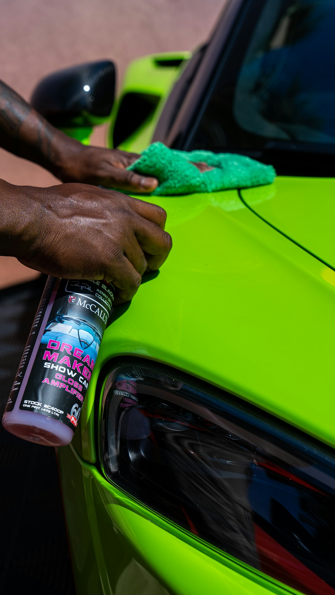 a person cleaning a car with a sponge