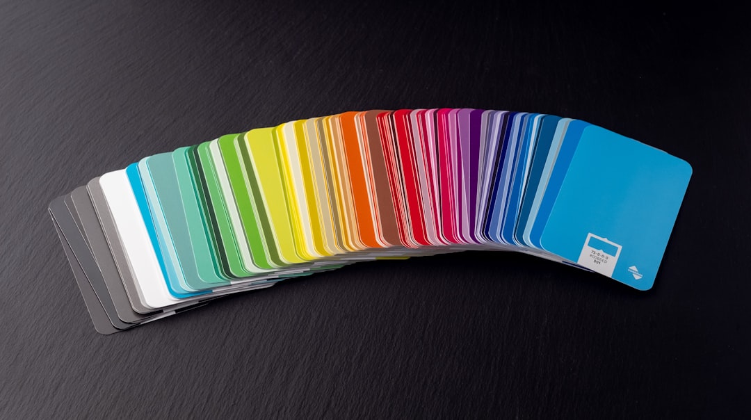 Swatchos color swatch cards with CMYK and RGB hex values showing fanned out in a rainbow