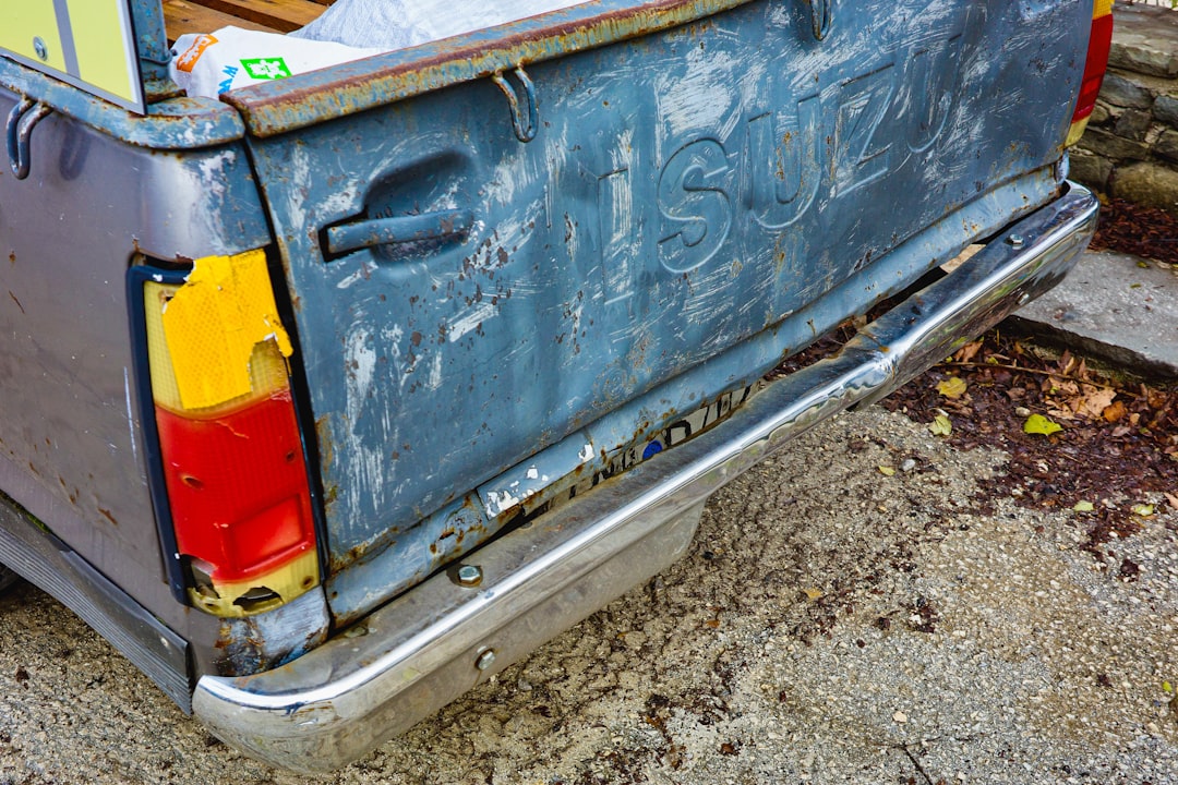 A blue truck with a yellow and red tailgate